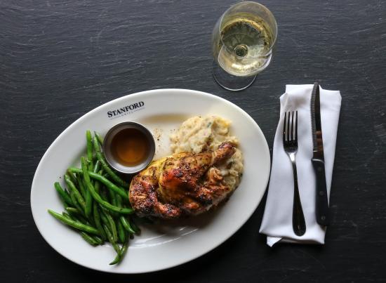 GreenFire signature dishes Wood-Fired Rotisserie Chicken, Cedar Plank Salmon, Bone-in Ribeye, Artisan Pizzas